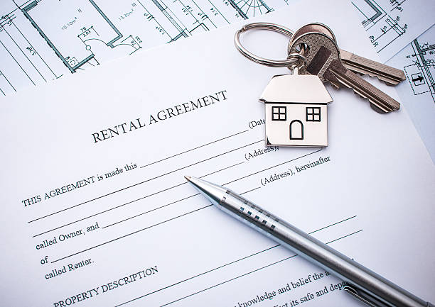 Rental agreement document with keys and pencil